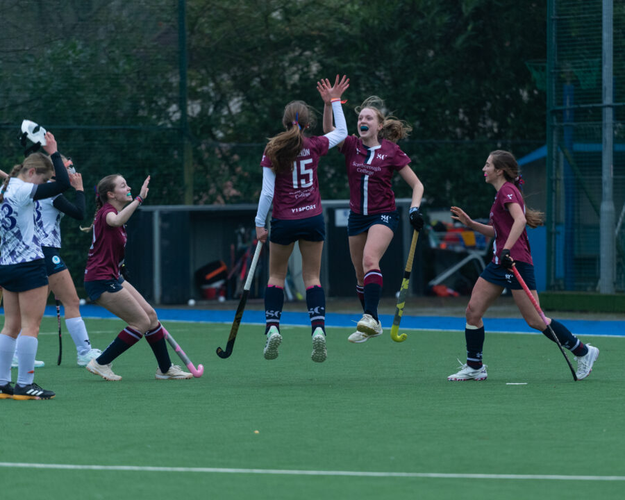 Senior Girls' Hockey team celebrating scoring